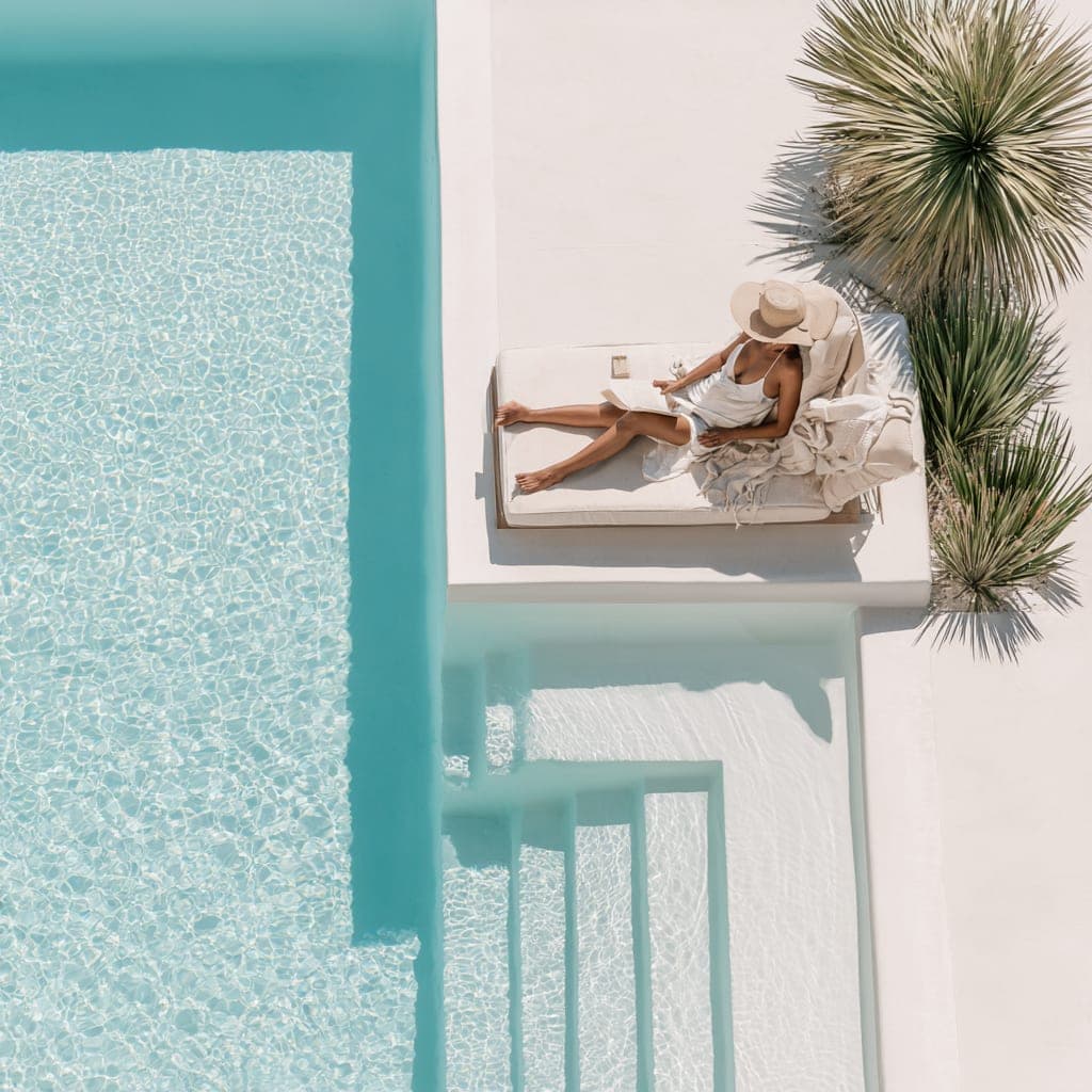 An owner relaxing by the pool of their own holiday home